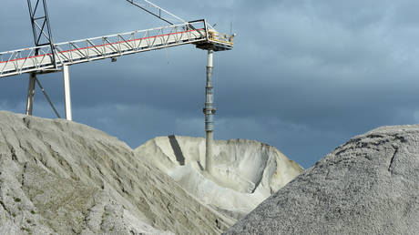 Lithium ore falls from a chute onto a stockpile at a facility in Australia