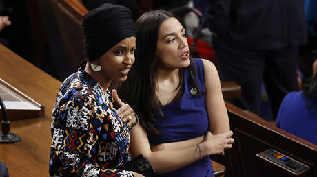 Rep. Ilhan Omar (D-MN) (L) and Rep. Alexandria Ocasio-Cortez (D-NY) in the House Chamber in Washington, DC, January 3, 2023.