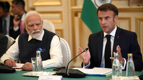 France's President Emmanuel Macron speaks as India's Prime Minister Narendra Modi listens on during a meeting at The Ministry of Foreign Affairs in Paris on July 14, 2023.