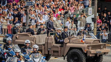 President of the French Republic Emmanuel Macron seen arriving with the Chief of Staff of the Armed Forces Thierry Burkhard in a troop vehicle, at Place de la Concorde.