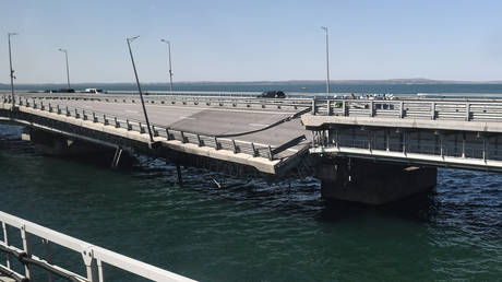 A view through a train window shows the damaged section of the Crimean Bridge, July 17, 2023