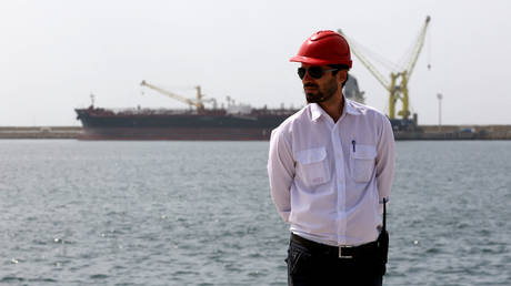 An engineer stands during an inauguration ceremony of new equipment and infrastructure at Shahid Beheshti Port in the southeastern Iranian coastal city of Chabahar, on the Gulf of Oman, on February 25, 2019.