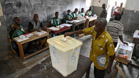 A Malian national living in Abidjan casts his ballot during voting for the referendum on the draft of the new Malian constitution in the district of Adjame, Ivory Coast on June 18, 2023.