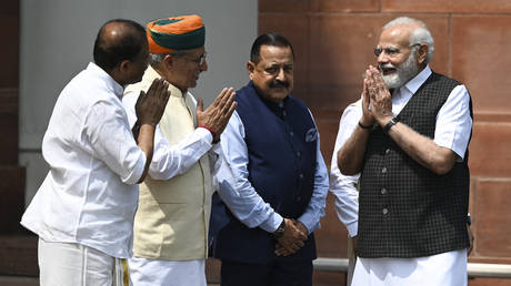 India's Prime Minister Narendra Modi (R) arrives to speak to the media before the opening of the Monsoon session of Parliament in New Delhi on July 20, 2023.