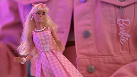 A woman holds a Barbie doll after watching the "Barbie" film at the SM North Edsa in Quezon City on July 19, 2023.