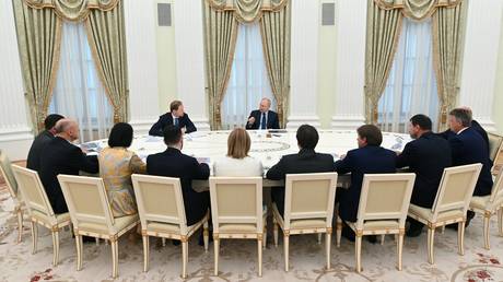 President Vladimir Putin chairing a meeting with the heads of Russia's manufacturing enterprises at the Kremlin on August 3, 2023.