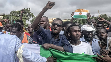 Protesters gesture during a demonstration on independence day in Niamey on August 3, 2023.
