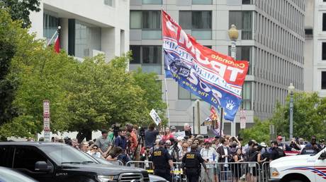 People watch after former President Donald Trump arrived at the E. Barrett Prettyman US Federal Courthouse, August 3, 2023