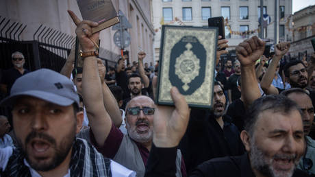 People hold copies of the Quran during a protest outside the Swedish Consulate on July 30, 2023 in Istanbul, Turkey