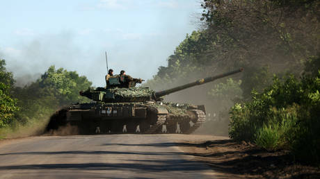 FILE PHOTO. Ukrainian servicemen drive a tank on a road near the front line in the Donetsk region.