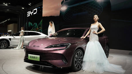 FILE PHOTO: Models pose near the latest offering from Chinese automaker BYD during the Auto Shanghai 2023 show in Shanghai, April 19, 2023