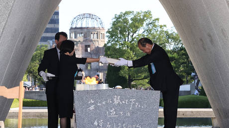 Hiroshima Mayor Kazumi Matsui (R) and representatives of bereaved families enshrine a list of atomic bomb victims at the Peace Memorial Park in Hiroshima, Japan, August 6, 2023