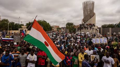 Protesters hold a Niger flag during a demonstration on independence day in Niamey on August 3, 2023.