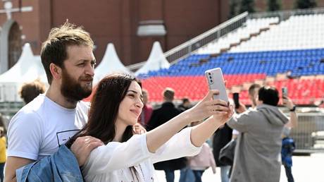 FILE PHOTO. Couple taking a selfie on Red Square in Moscow.