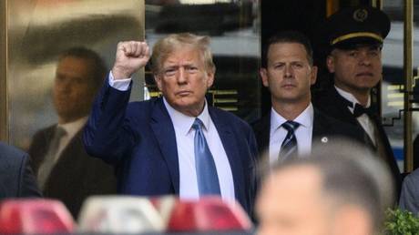 Donald Trump pumps his fist as he departs Trump Tower in New York City, April 13, 2023