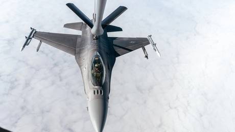 FILE PHOTO: A US F-16 is refueled by a KC-135 Stratotanker during a drill over an undisclosed location, January 26, 2023.