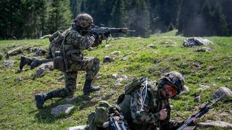 Swiss soldiers take part in a military drill near Les Geneveys-sur-Coffrane, Switzerland, May 4, 2023