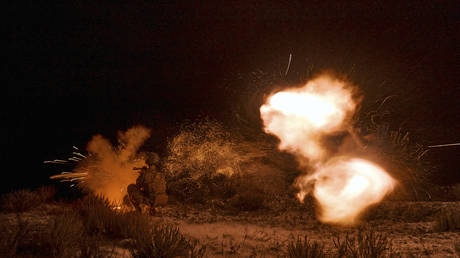 A Ukrainian soldier fires during night training in the Donetsk region, August 17, 2023.
