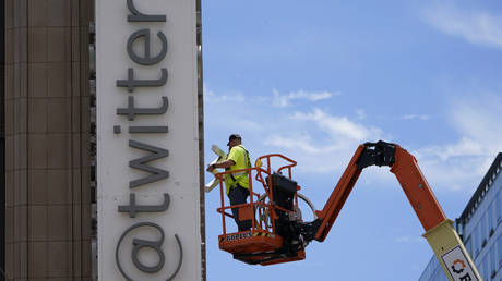 FILE PHOTO: A workman removes a sign on the Twitter headquarters in San Francisco, July 24, 2023.