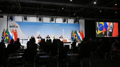 Participants attend a news conference as Russian President Vladimir Putin delivers his remarks virtually during the 15th BRICS Summit at the Sandton Convention Centre in Johannesburg, South Africa.