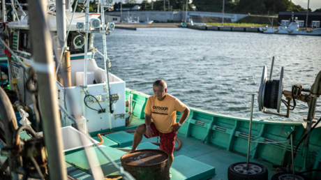 A Japanese fisherman on a fishing boat at Tsurushihama Port, Shinchi-machi, Fukushima Prefecture