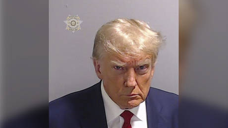 Former US President Donald Trump poses for his booking photo at the Fulton County Jail on August 24, 2023 in Atlanta, Georgia, United States.