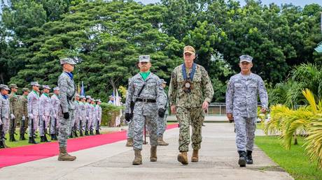 US Navy Vice Admiral Karl Thomas (center) visits with leaders in the Philippines during a port call earlier this month in Puerto Princesa.