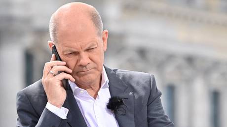 FILE PHOTO: German chancellor Olaf Scholz speaks on his mobile phone.