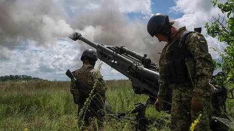 FILE PHOTO: Ukrainian servicemen are firing from an M777 howitzer.