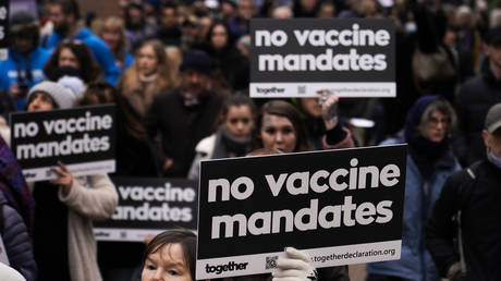 People hold placards as they attend an anti-vaccine protest in London, Britain, January 22, 2022