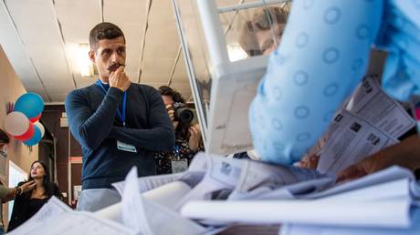 FILE PHOTO: A foreign observer monitors ballot counting at a polling station in Genichesk in Kherson Region