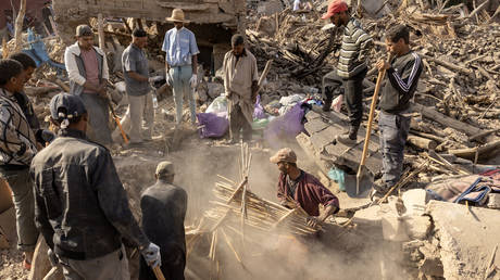 Volunteers dig in the rubble of collapsed houses in the village of Imi N'Tala near Amizmiz in central Morocco after the deadly 6.8-magnitude September 8 earthquake, on September 10, 2023.