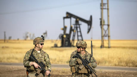 US troops patrol near an oil well in al-Qahtaniyah, Syria, June 14, 2023