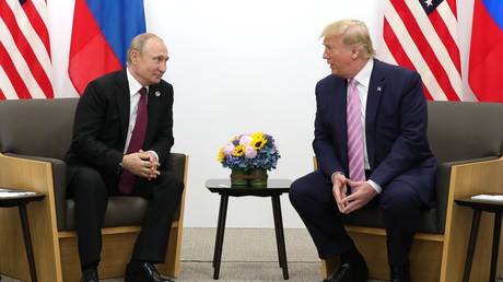 FILE PHOTO: Then-US President Donald Trump meets Russian President Vladimir Putin at the G20 summit in Osaka, Japan