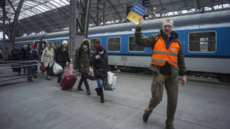 FILE PHOTO: A volunteer guiding refugees from Ukraine at the main railway station in Prague, Czech Republic, March 7, 2022.