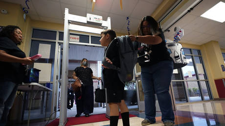Students pass through a metal detector at Freedom Elementary School in San Antonio, Texas, August 23, 2023.