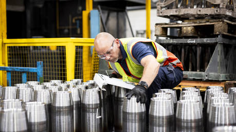 A BAE Systems employee inspects 155mm shell bodies at a production line in Washington, Britain, July 11, 2023