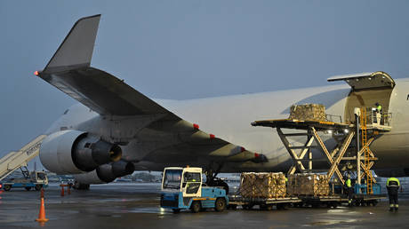 FILE PHOTO: Employees unload a plane carrying US military aid at Kiev's Borispol airport.
