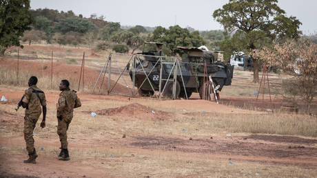 FILE PHOTO: Burkina Faso army officers patrol near a French armoured vehicle on November 20, 2021.