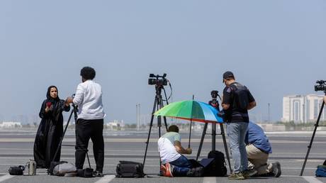 Members of the media wait at a terminal for a jet carrying five US citizens at the Doha International Airport in Doha, Qatar, September 18, 2023