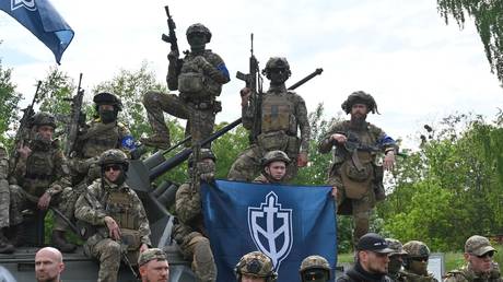 Ukrainian paramilitary unit the Russian Volunteer Corps, poses for the media in northern Ukraine, not far from the Russian border, on May 24, 2023