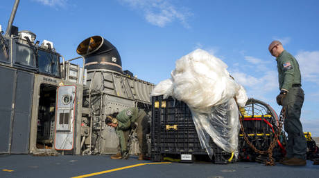  In this image released by the U.S. Navy,  sailors assigned to Assault Craft Unit 4 prepare material recovered off the coast of Myrtle Beach, S.C., in the Atlantic Ocean from the shooting down of a Chinese high-altitude balloon, for transport to the FBI on Feb. 10, 2023.