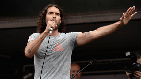 Russell Brand speaks to thousands of demonstrators gathered in Parliament Square to protest against austerity and spending cuts on June 20, 2015 in London, England