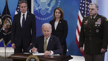 FILE PHOTO: US Secretary of State Antony Blinken (L) and Chairman of the Joint Chiefs of Staff General Mark Milley (R) attend as President Joe Biden signs a Ukraine aid document