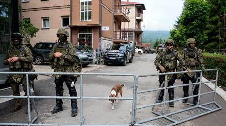 NATO-led Kosovo Force (KFOR) soldiers stand behind a barbed wire perimeter around the municipal building in Zvecan, Kosovo, June 2, 2023
