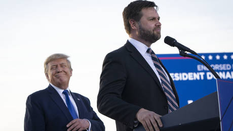 Former President Donald Trump listens as J.D. Vance, a Republican candidate for U.S. Senate in Ohio, speaks during a rally hosted by the former president at the Delaware County Fairgrounds on April 23, 2022 in Delaware, Ohio