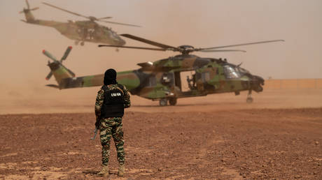 FILE PHOTO. A soldier of the French Special and Intervention Unit of the National Gendarmerie stands next to a NH90 Caiman Helicopter at the Ouallam's military base.