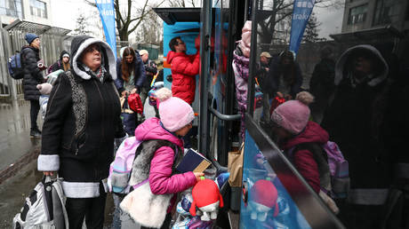 FILE PHOTO. People fleeing from Ukraine take a free bus to the Swiss city Sorula from Krakow, Poland