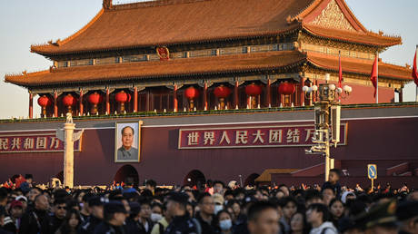FILE PHOTO: People attend a flag-raising ceremony to mark China’s National Day at Tiananmen Square in Beijing on October 1, 2023.
