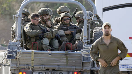 Israeli soldiers head south near Ashkelon, Israel, on Saturday, Oct. 7, 2023.